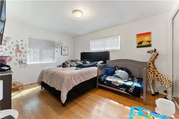 a bedroom with bed and a couch