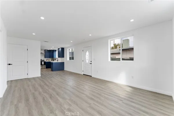 a view of a kitchen with a sink and a refrigerator