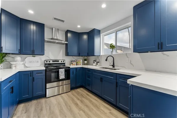a kitchen with a sink cabinets and stainless steel appliances