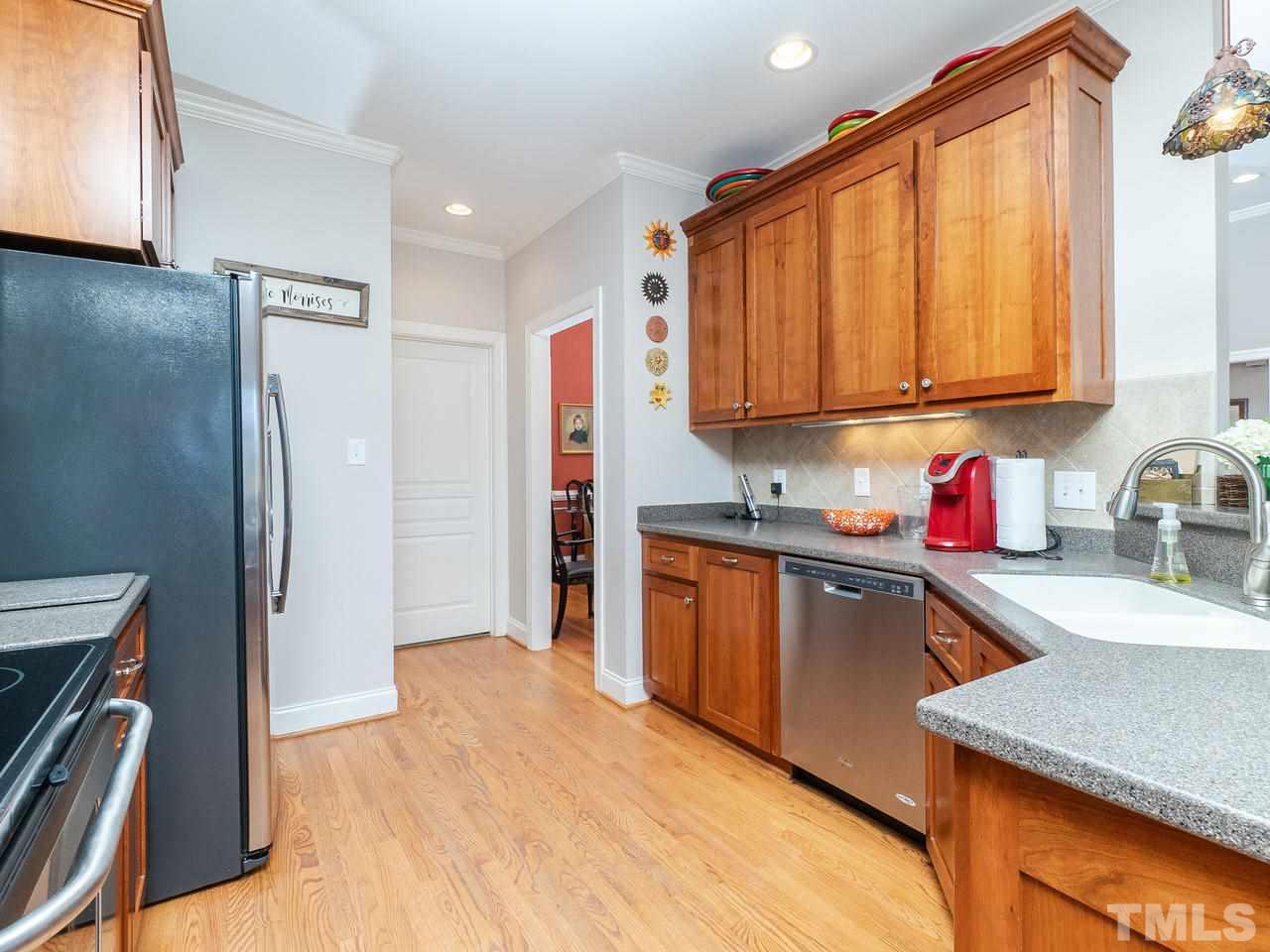 326 Challenge Road Raleigh, NC 27603 - Photo 11 of 30 a kitchen with stainless steel appliances granite countertop a refrigerator sink and cabinets