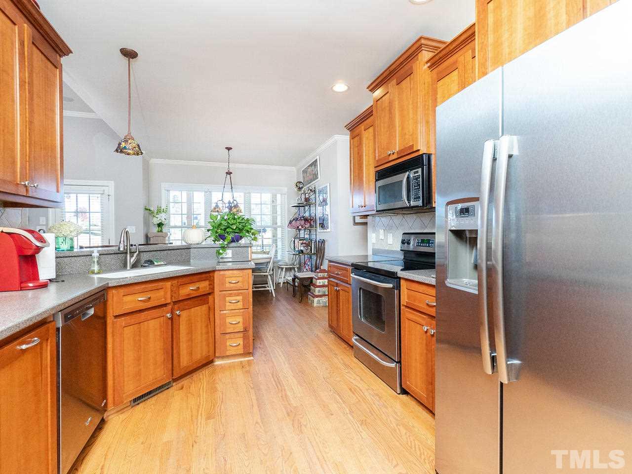 326 Challenge Road Raleigh, NC 27603 - Photo 13 of 30 a large kitchen with stainless steel appliances granite countertop a stove a sink and a refrigerator