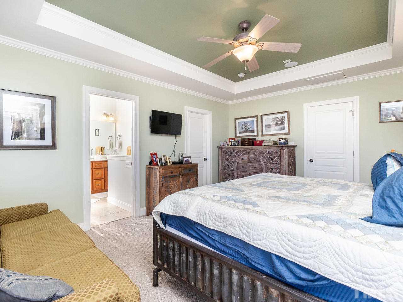 326 Challenge Road Raleigh, NC 27603 - Photo 16 of 30 a bed room with furniture and a flat screen tv