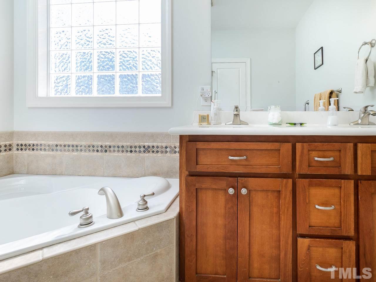 326 Challenge Road Raleigh, NC 27603 - Photo 18 of 30 a bathroom with a sink and a bathtub