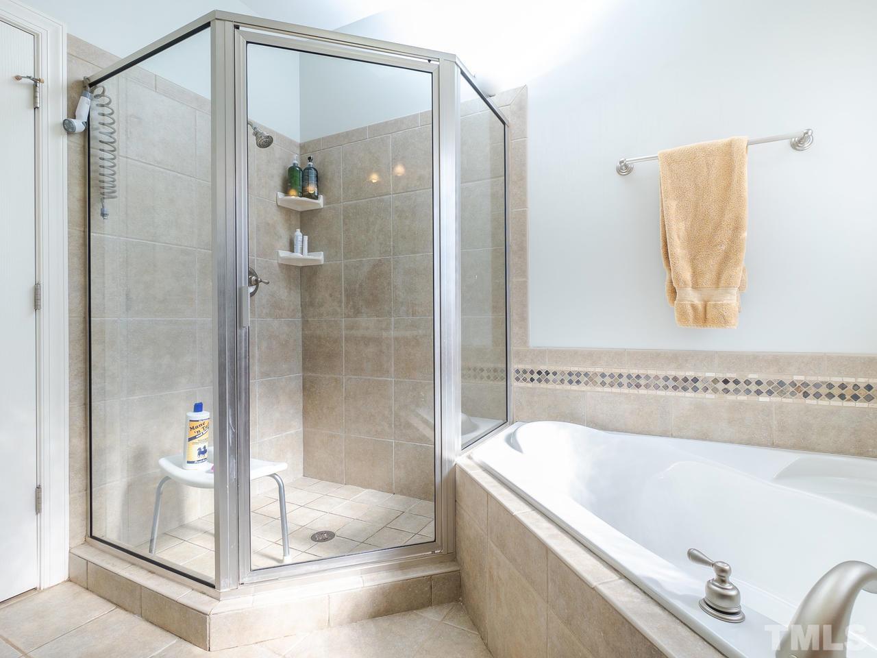 326 Challenge Road Raleigh, NC 27603 - Photo 19 of 30 a bathroom with a tub and shower