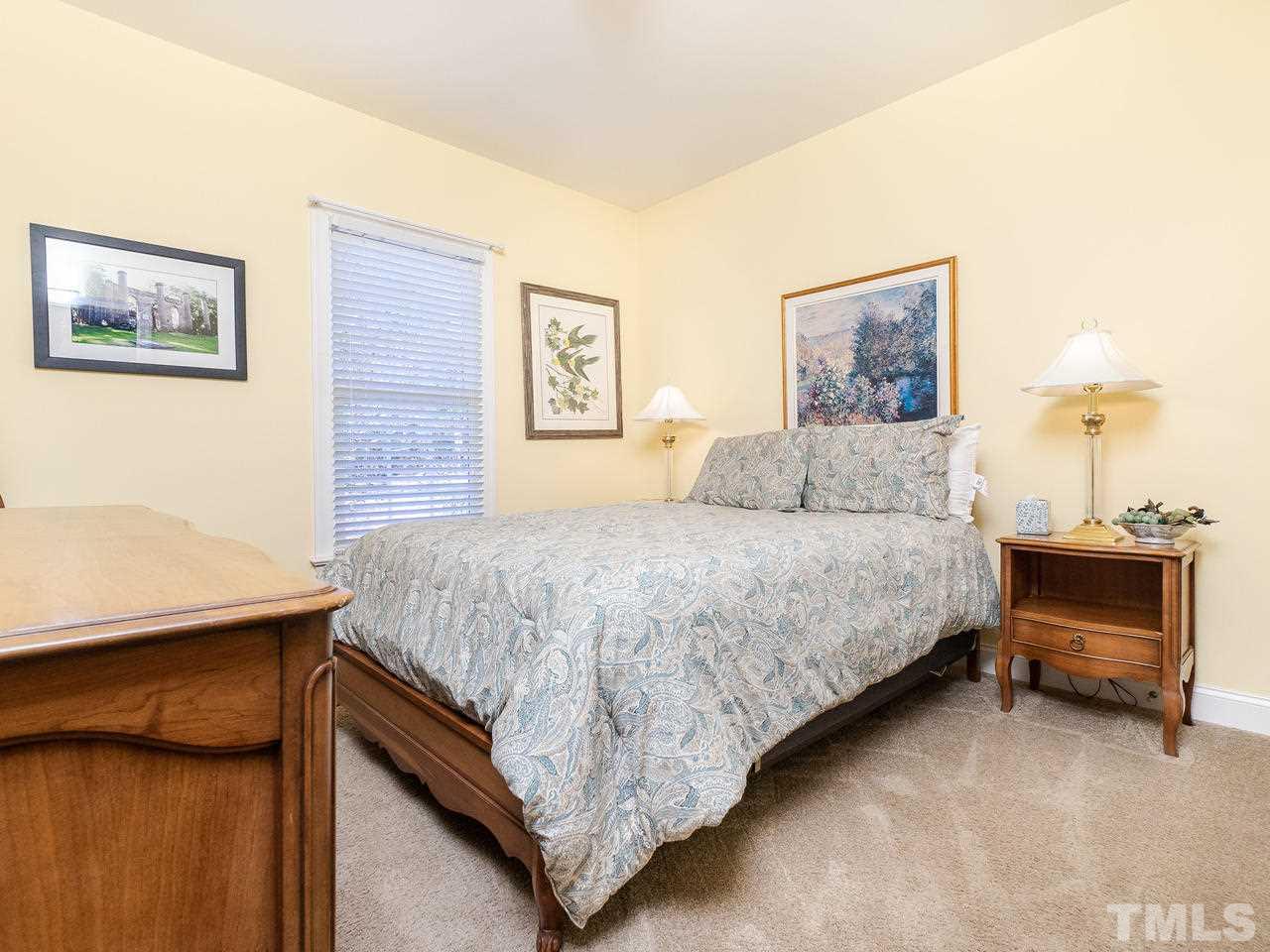 326 Challenge Road Raleigh, NC 27603 - Photo 20 of 30 a bedroom with a bed and a desk