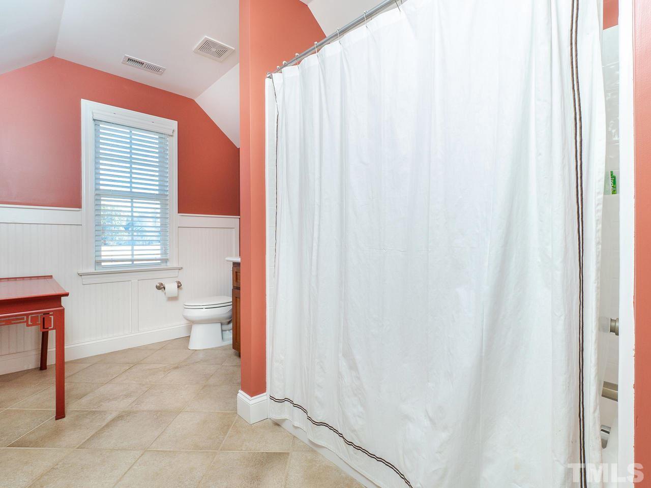 326 Challenge Road Raleigh, NC 27603 - Photo 25 of 30 a bathroom with a toilet sink and a mirror