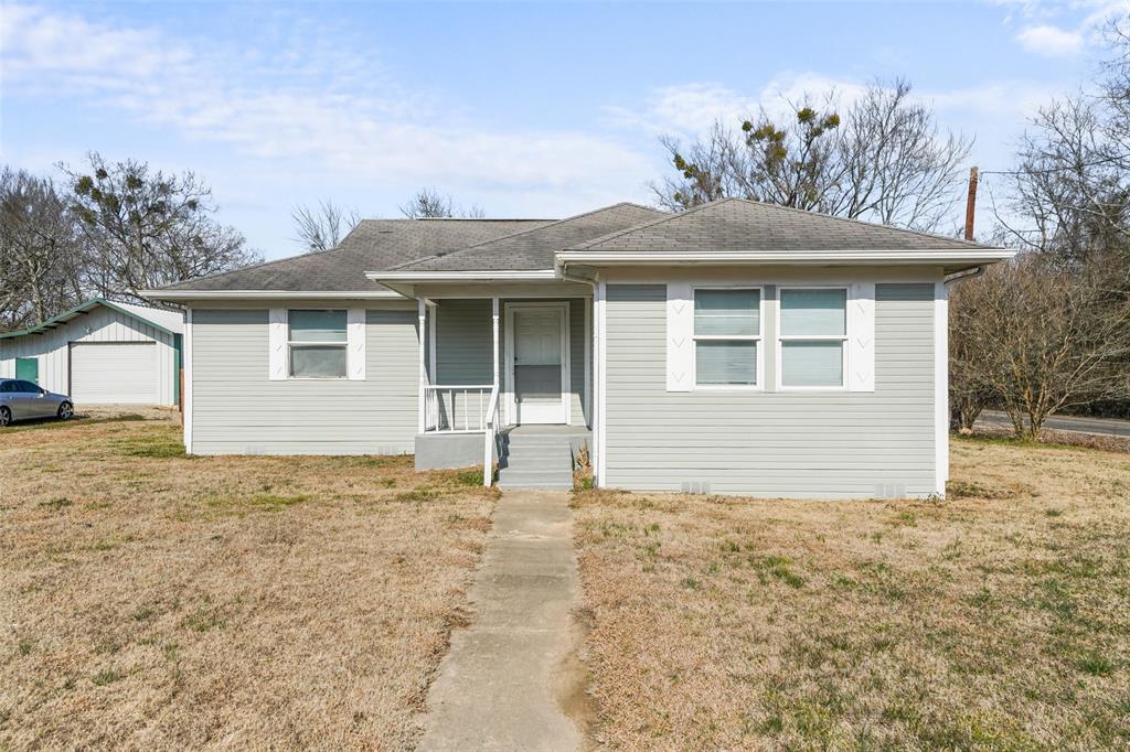 1145 Jefferson Road Paris, TX 75460 - Photo 2 of 17 a house with trees in the background