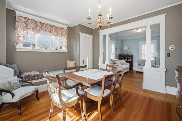 a view of a dining room with furniture wooden floor and chandelier
