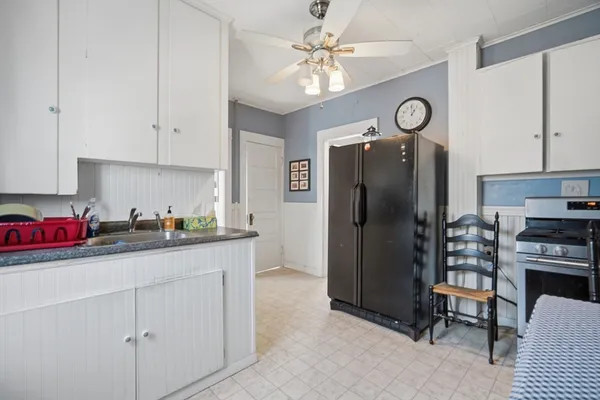 a kitchen with granite countertop a refrigerator a stove a sink and dishwasher