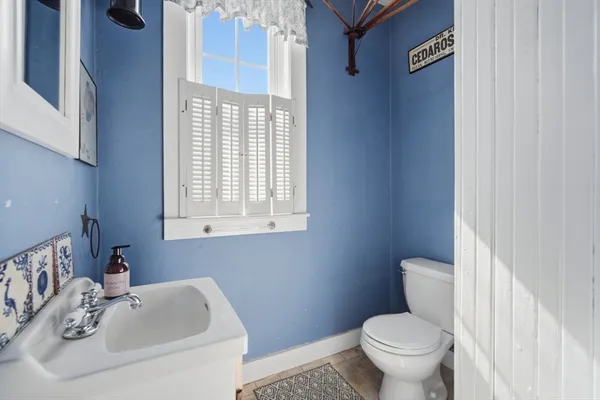 a white toilet sitting next to a bathroom sink