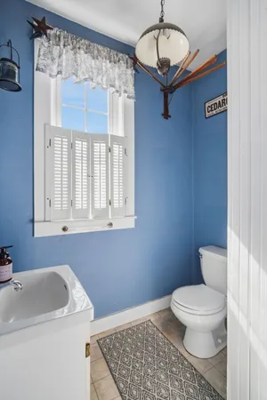 a bathroom with a toilet a sink and a mirror