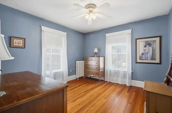 a view of a livingroom with furniture and a chandelier fan