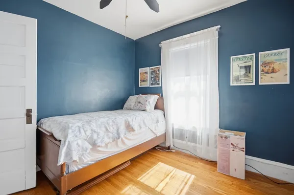 a bedroom with a bed and a window