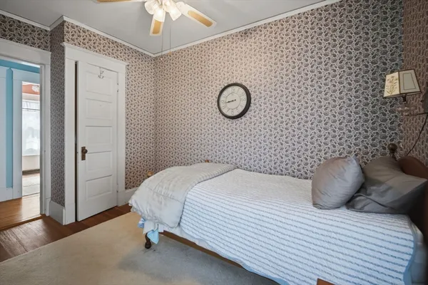 a bedroom with a bed and a chandelier