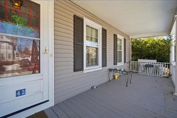 a view of a deck with couches with wooden floor and fence