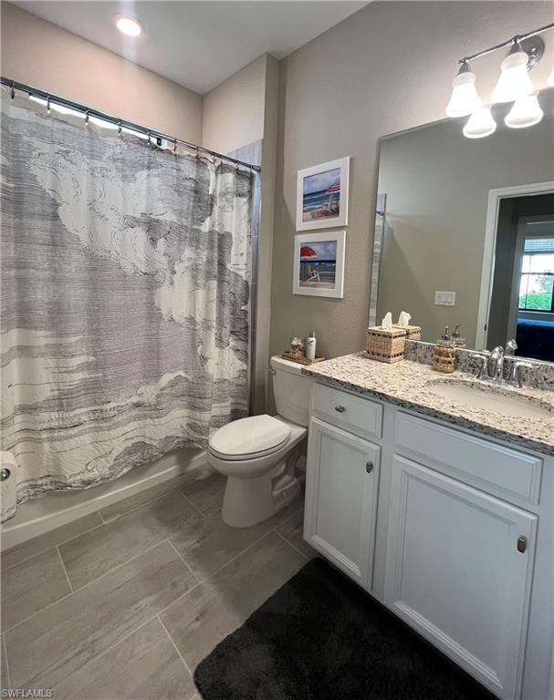 19824 Beechcrest Place Estero, FL 33928 - Photo 12 of 26 a bathroom with a double vanity sink toilet and shower