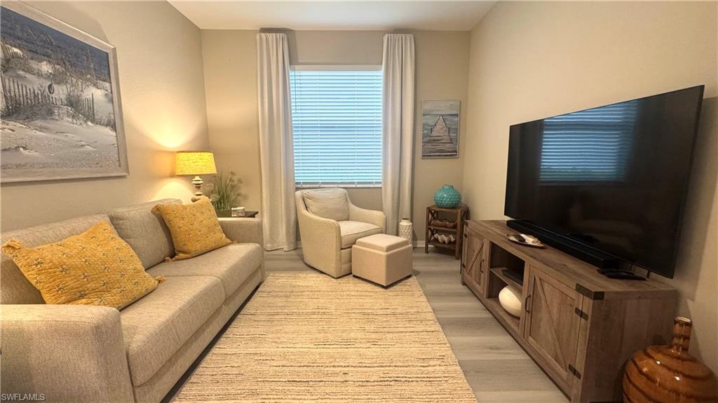 19824 Beechcrest Place Estero, FL 33928 - Photo 14 of 26 a living room with furniture and a flat screen tv