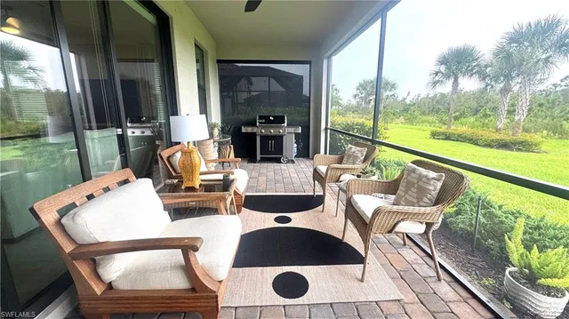 a view of balcony with furniture and garden