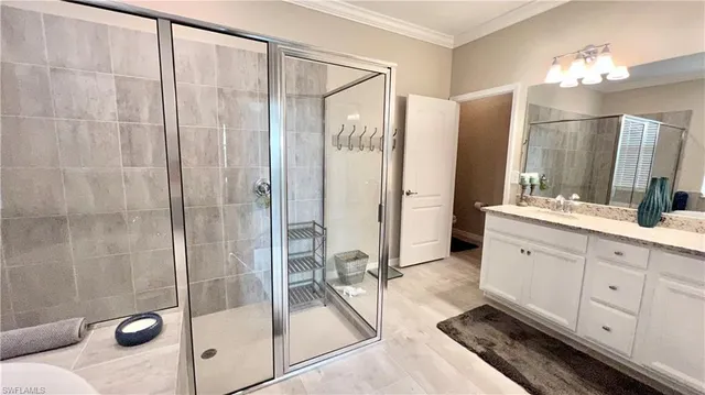 a bathroom with a double vanity sink mirror and shower