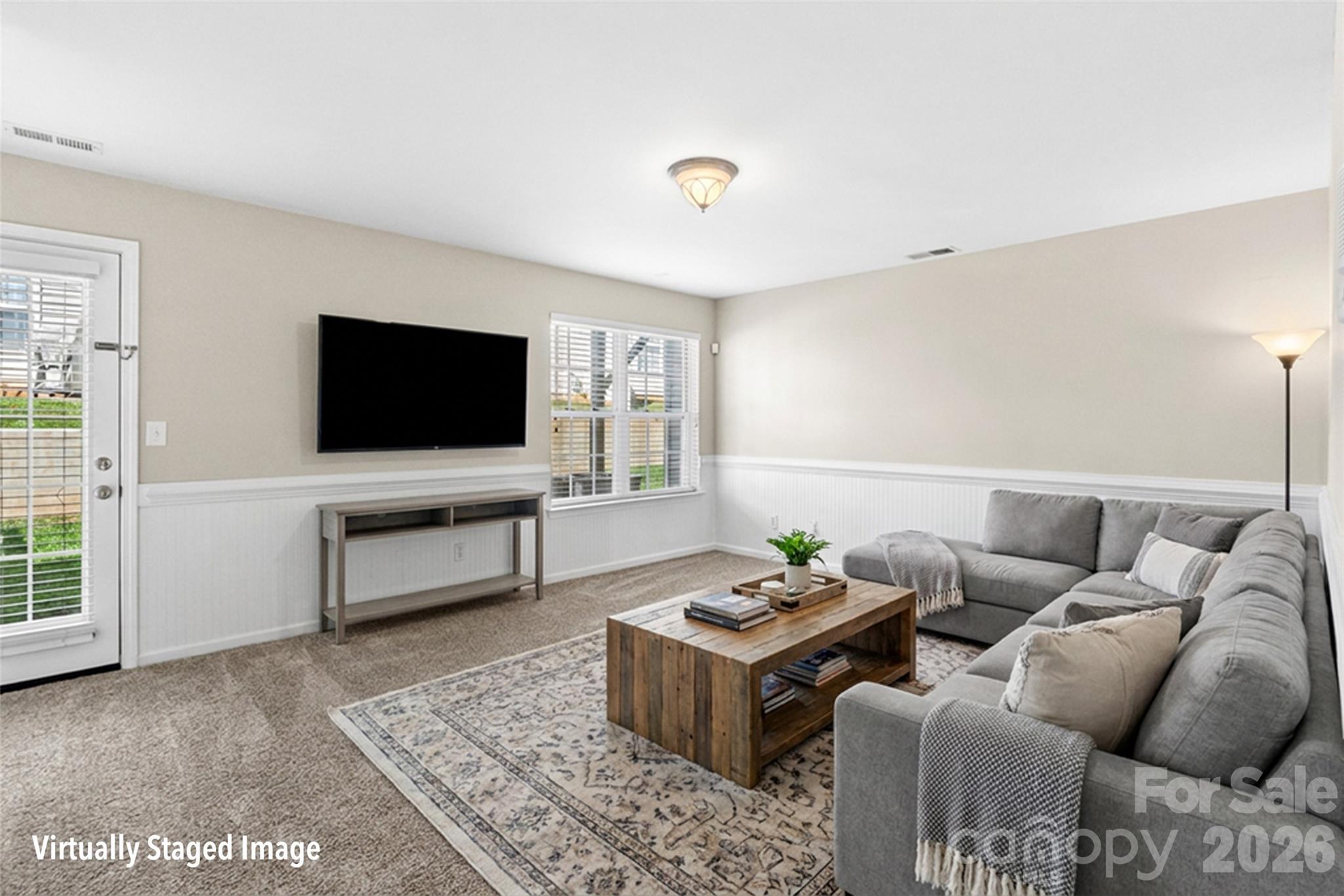 104 Rock Ridge Lane Mount Holly, NC 28120 - Photo 6 of 48 a living room with furniture and a flat screen tv