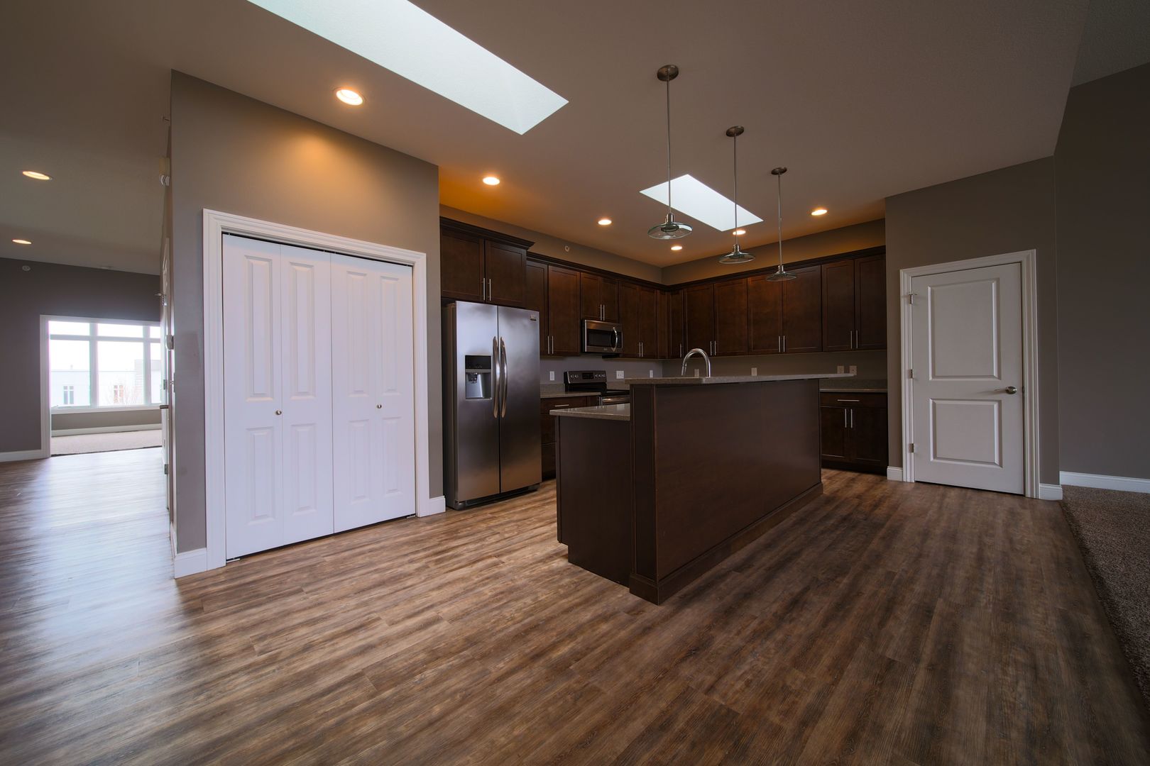 4935 Utica Ridge Road, Unit 220 Davenport, IA 52807 - Photo 11 of 29 a view of kitchen with refrigerator microwave and wooden floor