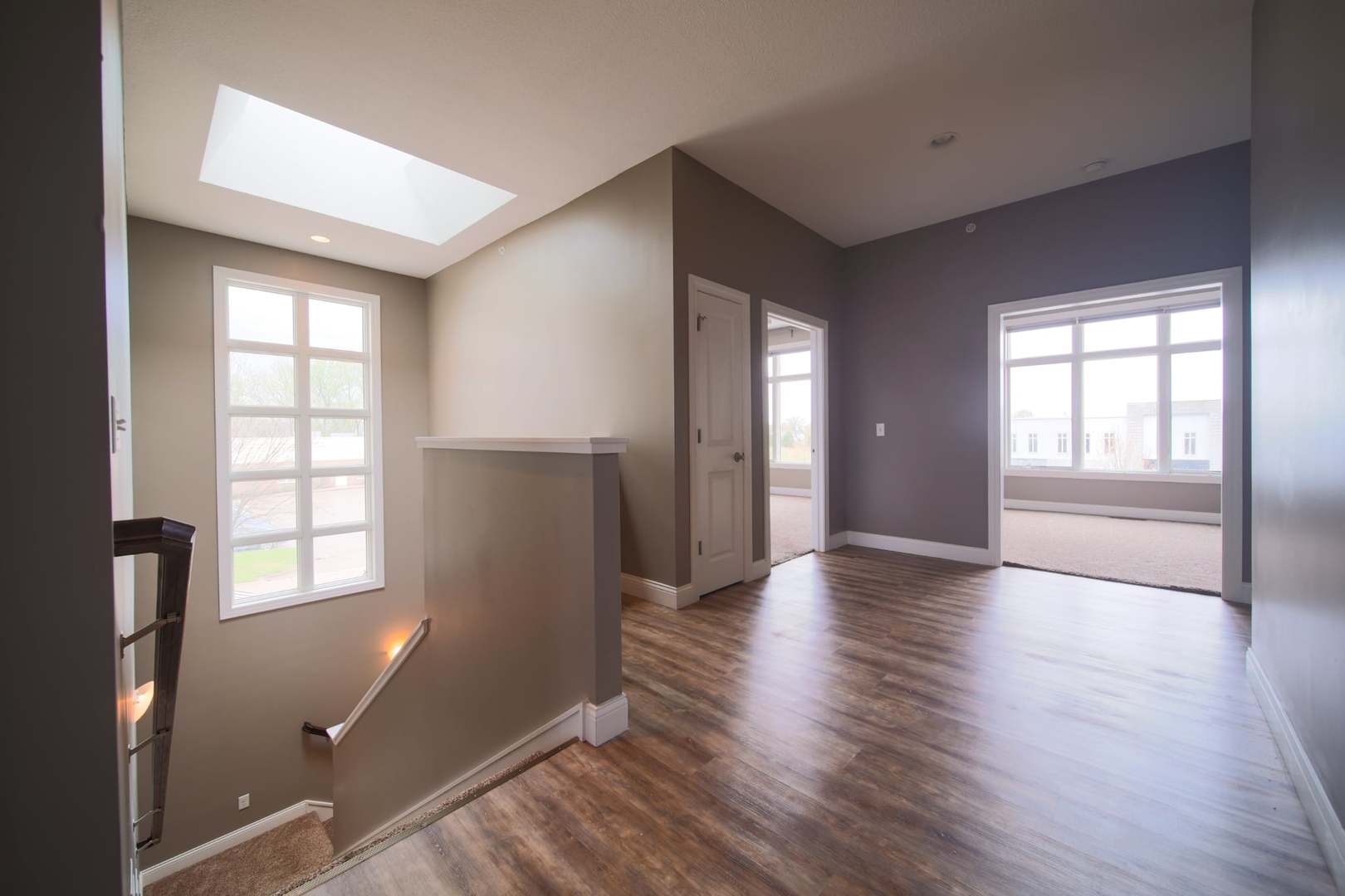 4935 Utica Ridge Road, Unit 220 Davenport, IA 52807 - Photo 15 of 29 a view of an empty room with wooden floor and a window