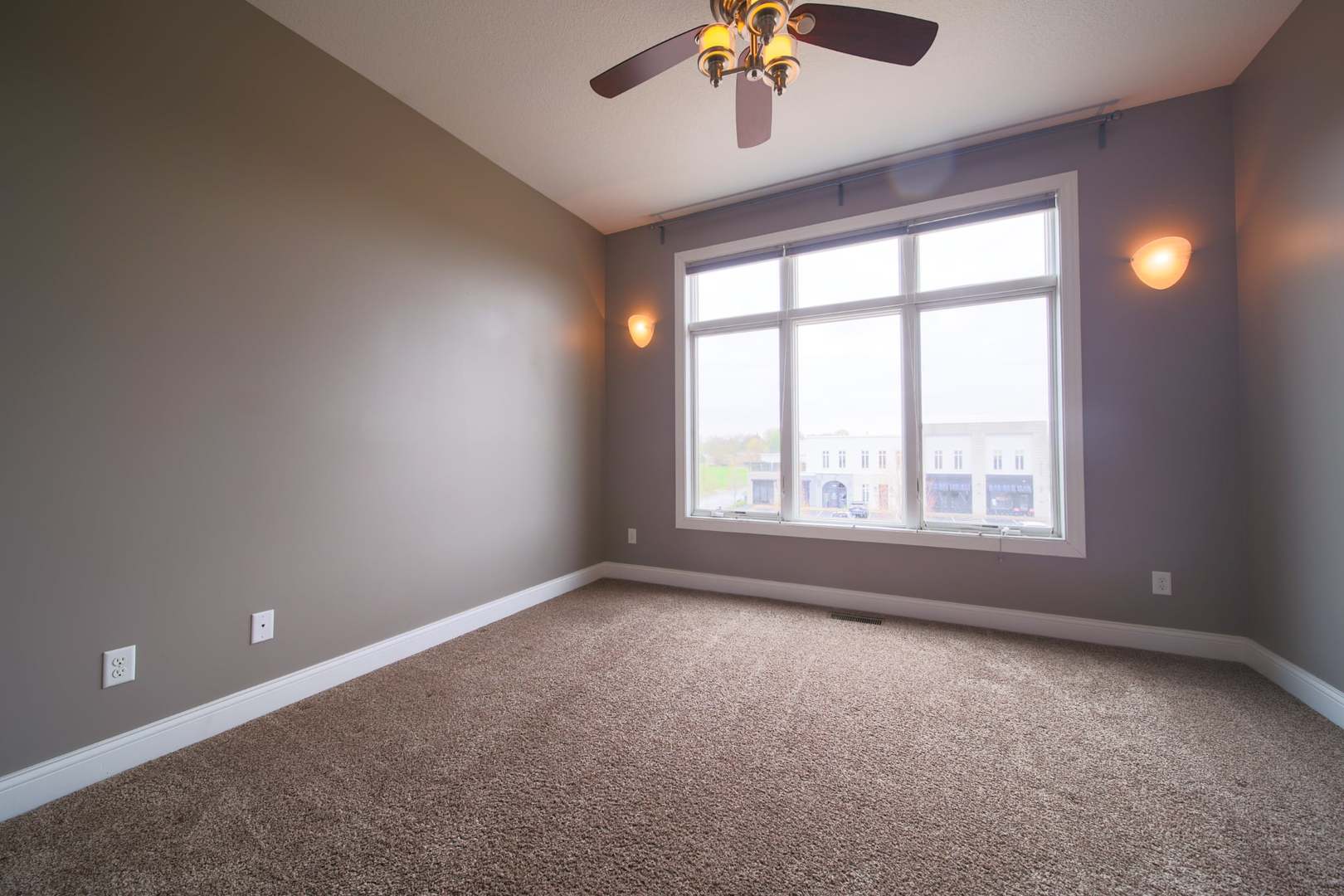 4935 Utica Ridge Road, Unit 220 Davenport, IA 52807 - Photo 17 of 29 an empty room with a window and ceiling fan