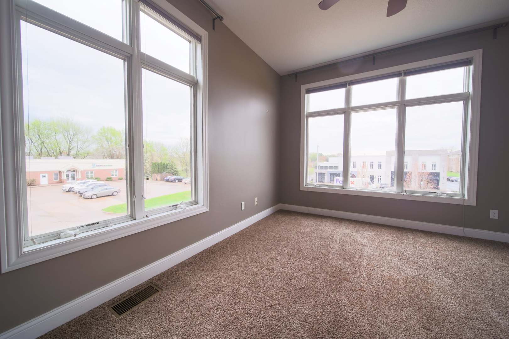 4935 Utica Ridge Road, Unit 220 Davenport, IA 52807 - Photo 18 of 29 an empty room with large windows
