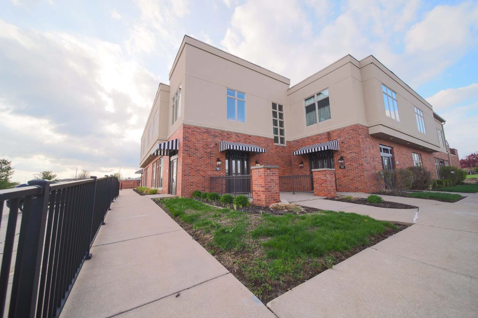 4935 Utica Ridge Road, Unit 220 Davenport, IA 52807 - Photo 2 of 29 a front view of a house with a garden