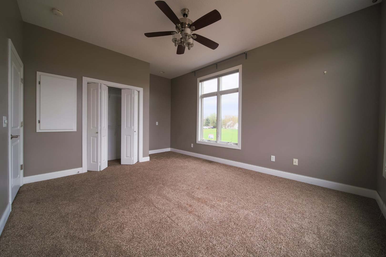 4935 Utica Ridge Road, Unit 220 Davenport, IA 52807 - Photo 27 of 29 an empty room with windows and fan