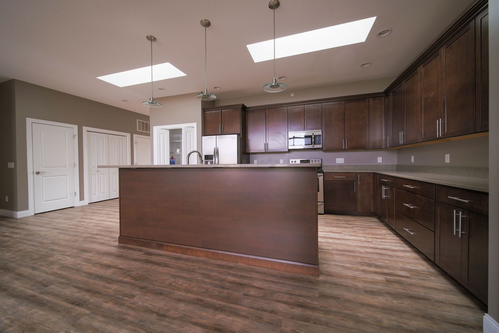 4935 Utica Ridge Road, Unit 220 Davenport, IA 52807 - Photo 10 of 29 a kitchen with stainless steel appliances granite countertop a sink a stove and a refrigerator