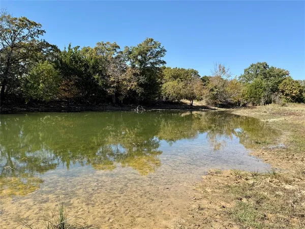 a view of a lake with a yard
