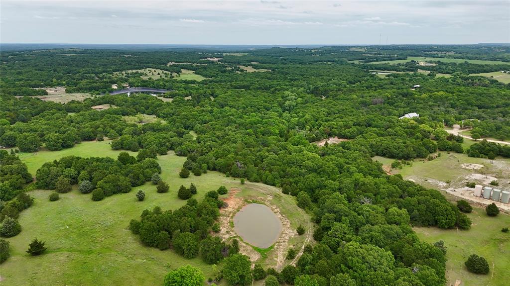 2753 Big Tree Road Montague, TX 76251 - Photo 35 of 40 an aerial view of residential houses with outdoor space and trees