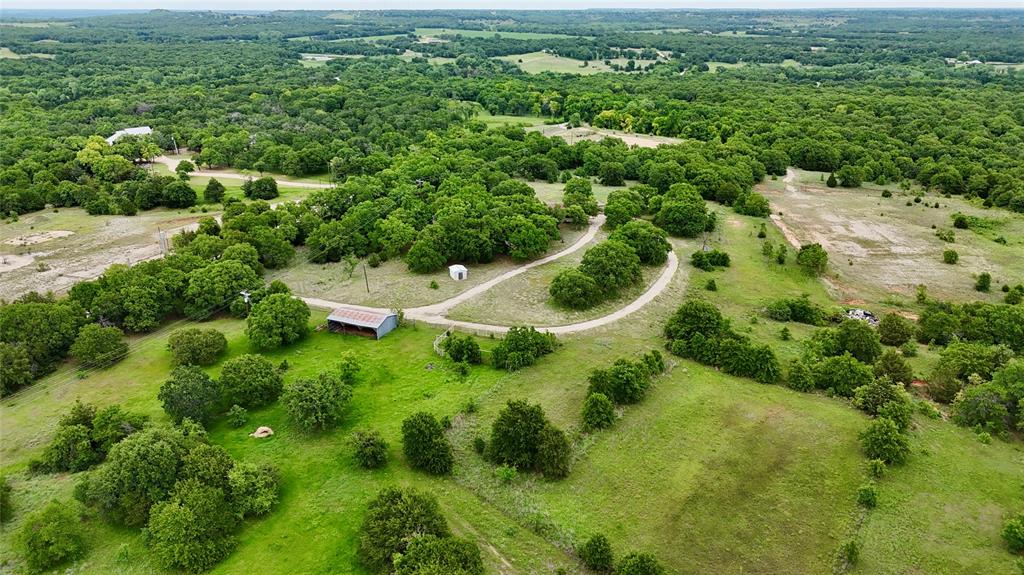 2753 Big Tree Road Montague, TX 76251 - Photo 40 of 40 an aerial view of residential house with outdoor space and trees all around