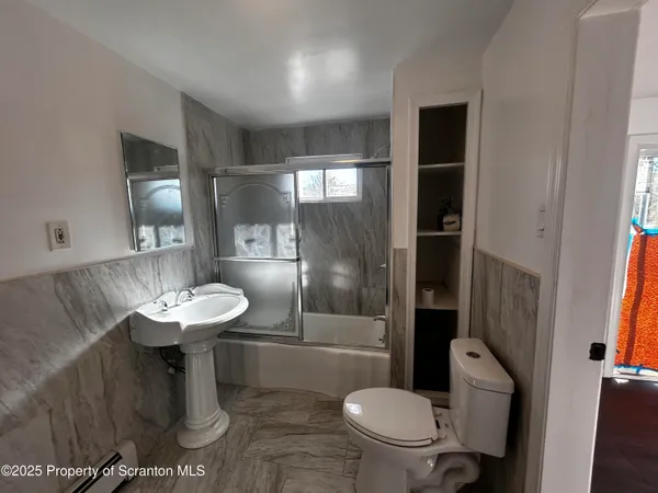 a bathroom with a sink toilet and a mirror