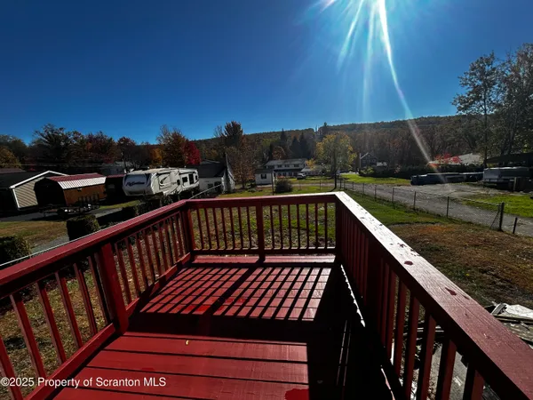 a view of balcony with wooden floor and outdoor seating