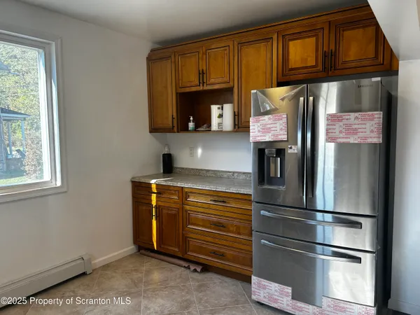 a kitchen with stainless steel appliances granite countertop a refrigerator and cabinets