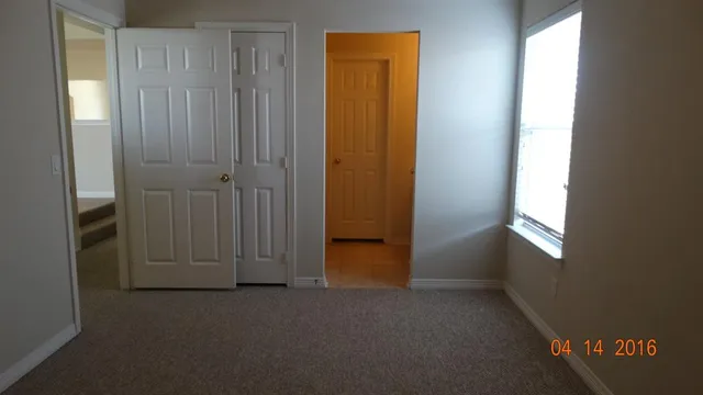 a bathroom with a granite countertop sink and window