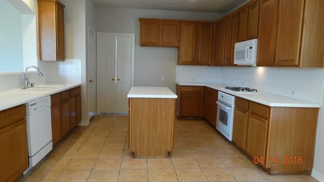 a kitchen with stainless steel appliances a sink stove and cabinets