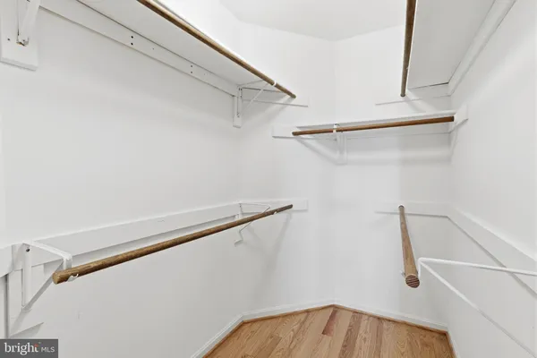 a view of walk in closet with empty racks