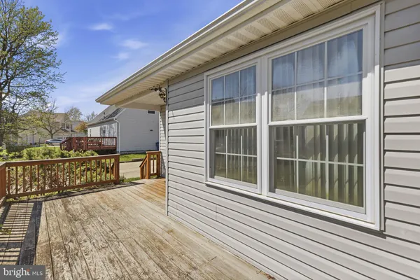 a view of a balcony with a large window and wooden floor