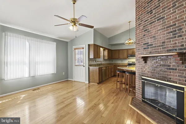 a kitchen with stainless steel appliances kitchen island granite countertop a refrigerator and a stove top oven