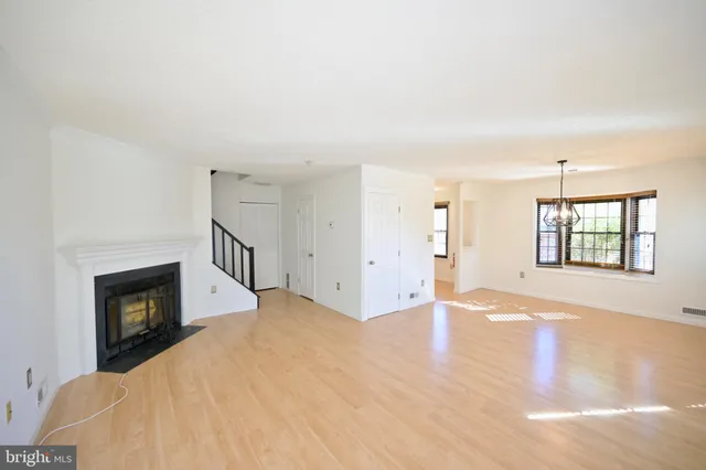 a view of empty room with a fireplace