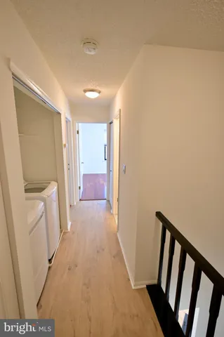 a view of hallway with washer and dryer