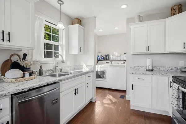 a kitchen with a white cabinets and window