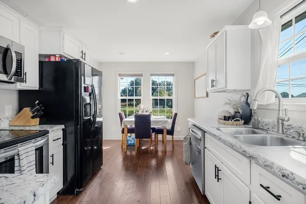 a kitchen with stainless steel appliances granite countertop a refrigerator stove and sink