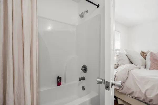a bathroom with a bathtub and shower