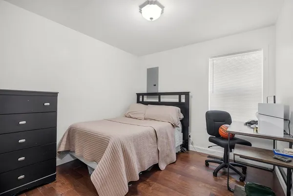 a bedroom with a bed and a desk