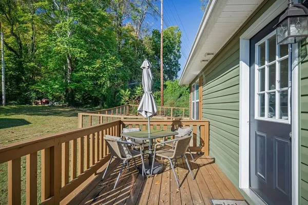 a view of balcony with furniture and wooden deck