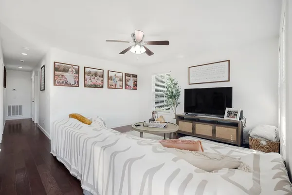 a bedroom with a bed and a flat screen tv